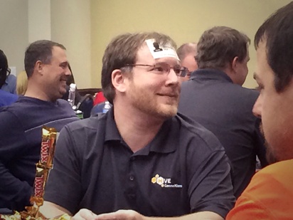 Man smiling with card on forehead during a workshop with keynote speaker Vicki Hitzges