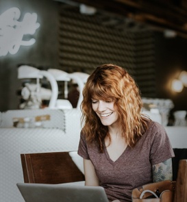 Smiling woman sitting at laptop